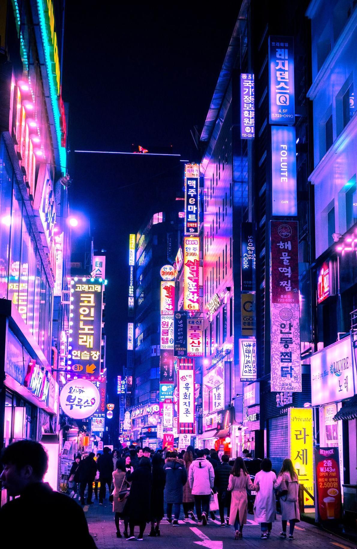 A busy street in Seoul at night with bright neon lights and signs. - Seoul