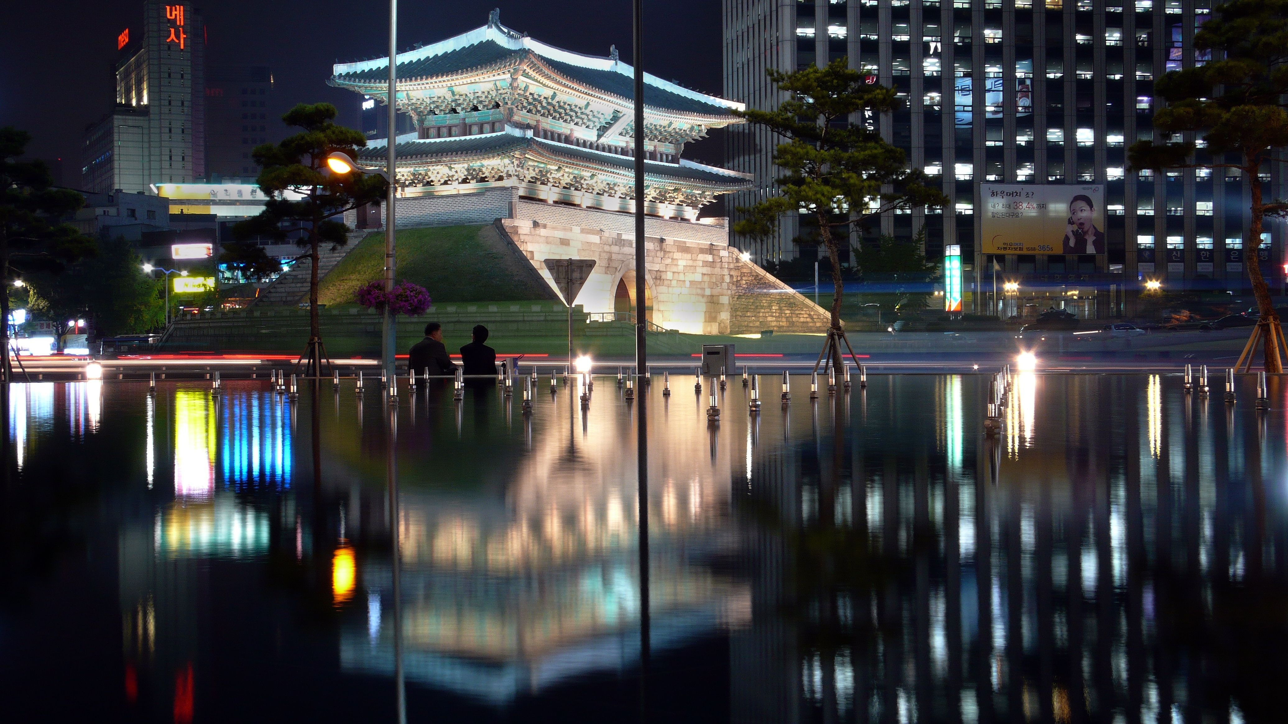 A reflection of buildings in water at night - Seoul