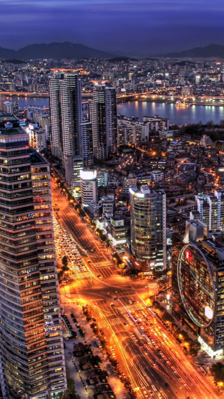 A night time cityscape of a city with tall buildings - Seoul