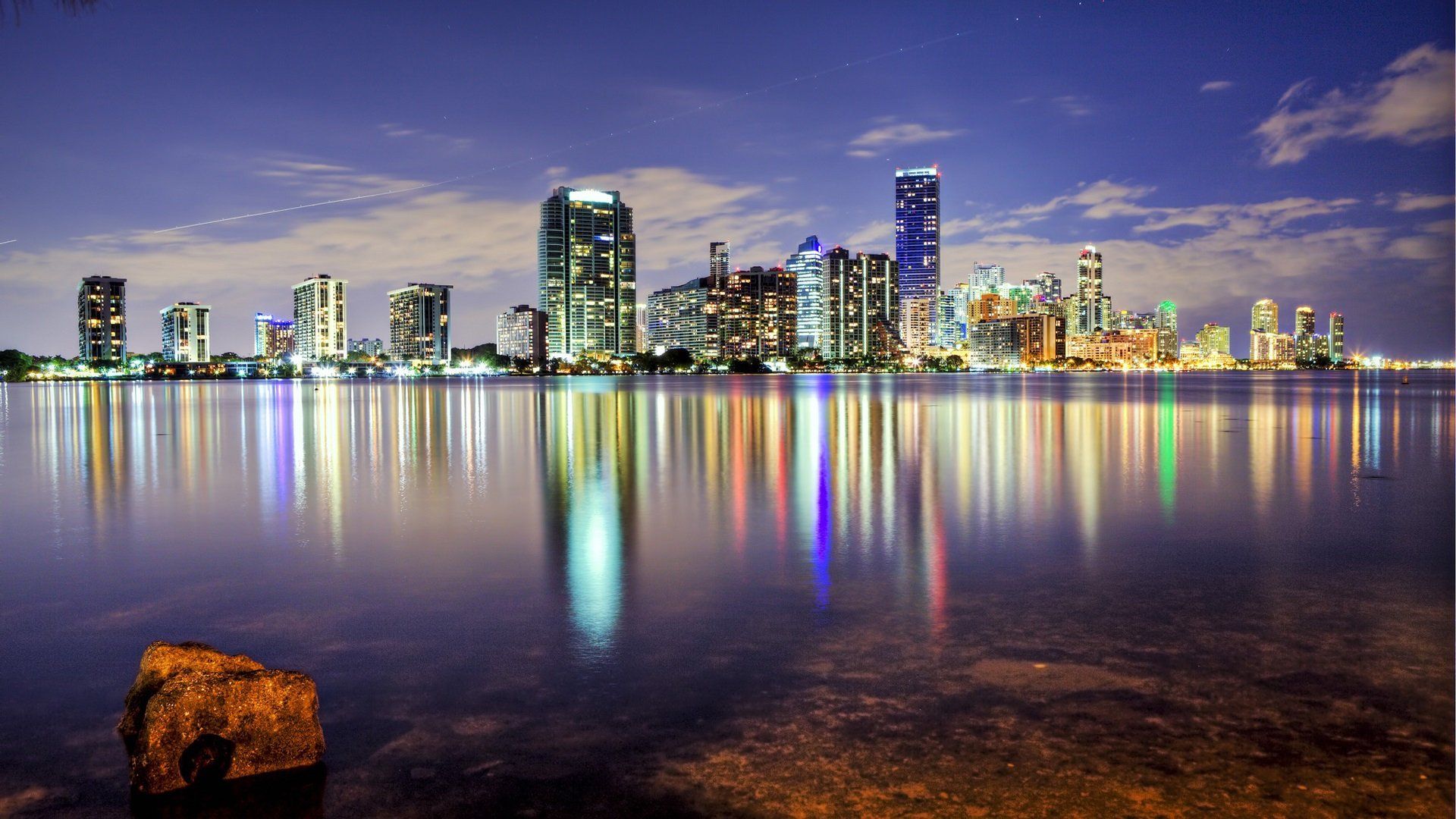 A city skyline reflected in the water - Miami