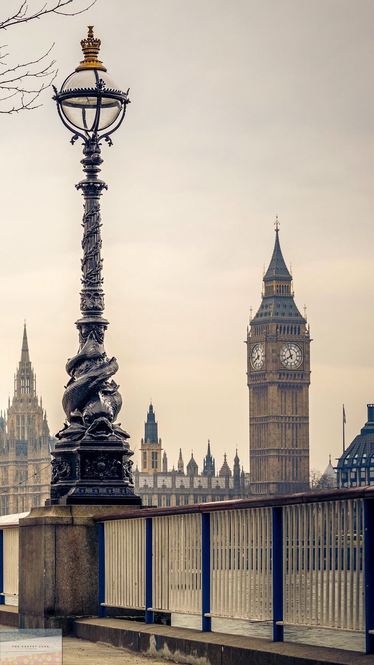 A clock tower and some buildings in the background - London