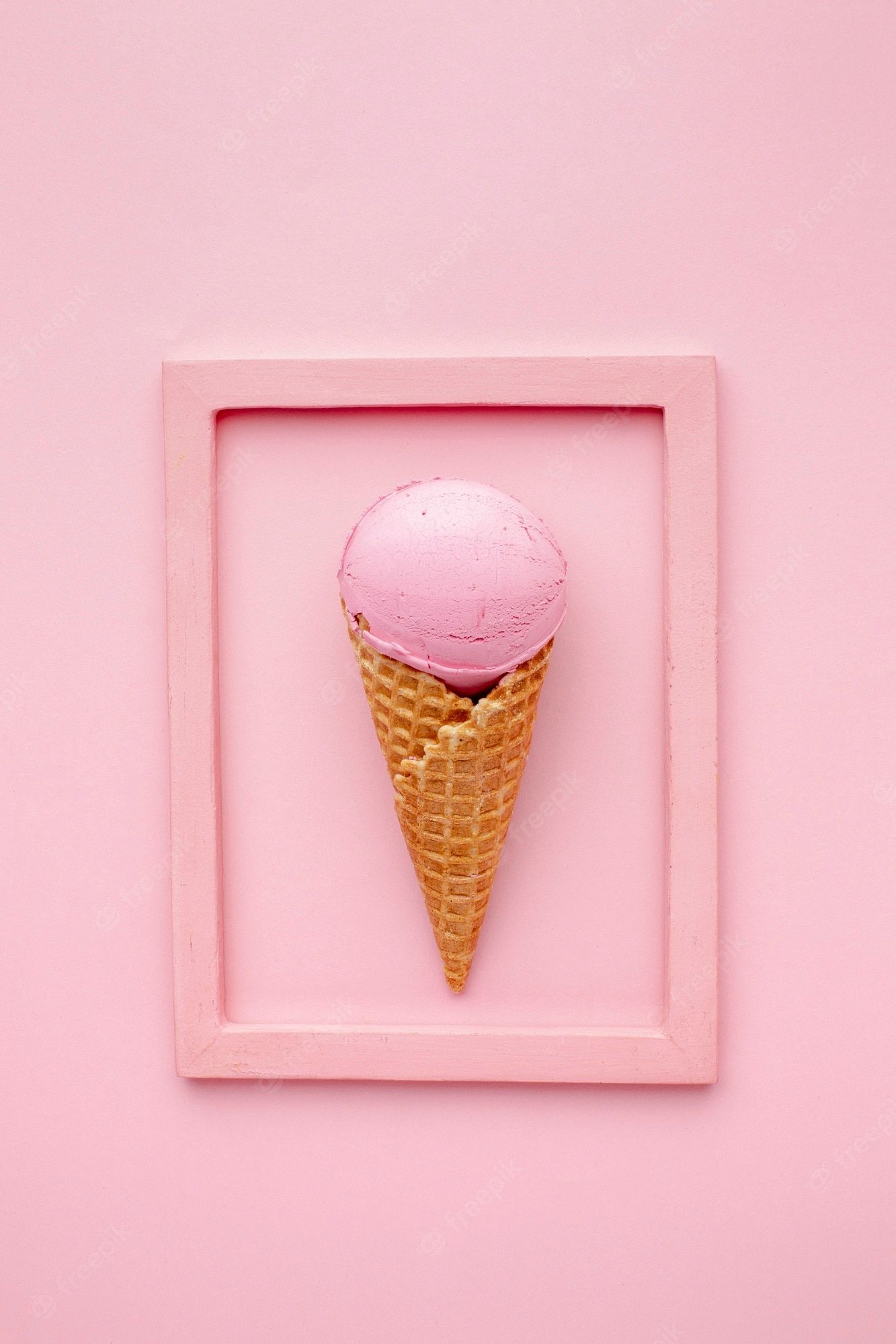 A pink ice cream cone in a pink frame on a pink background - Ice cream