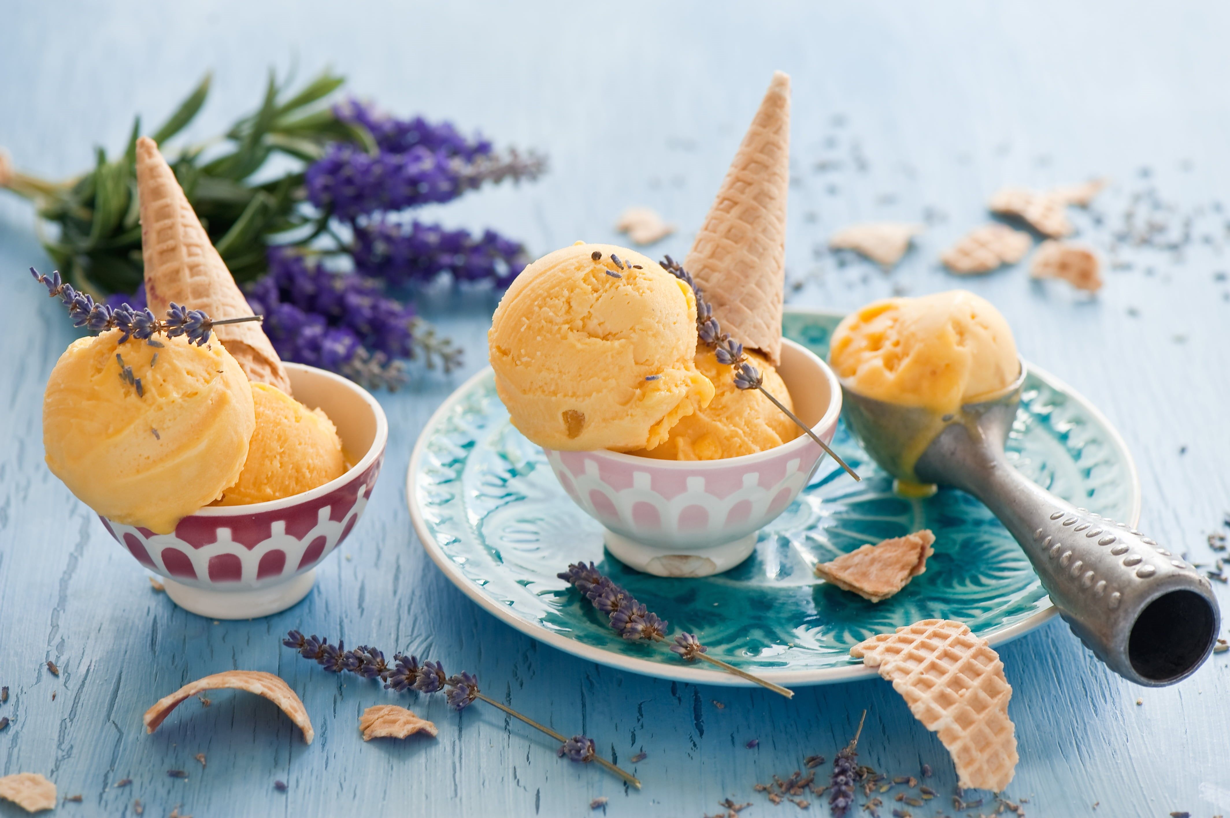 A few scoops of mango ice cream in bowls with cones - Ice cream