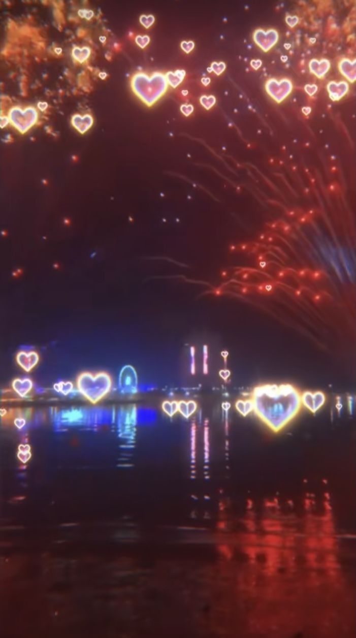 Fireworks and hearts light up the night sky in a stunning display. - Lovecore