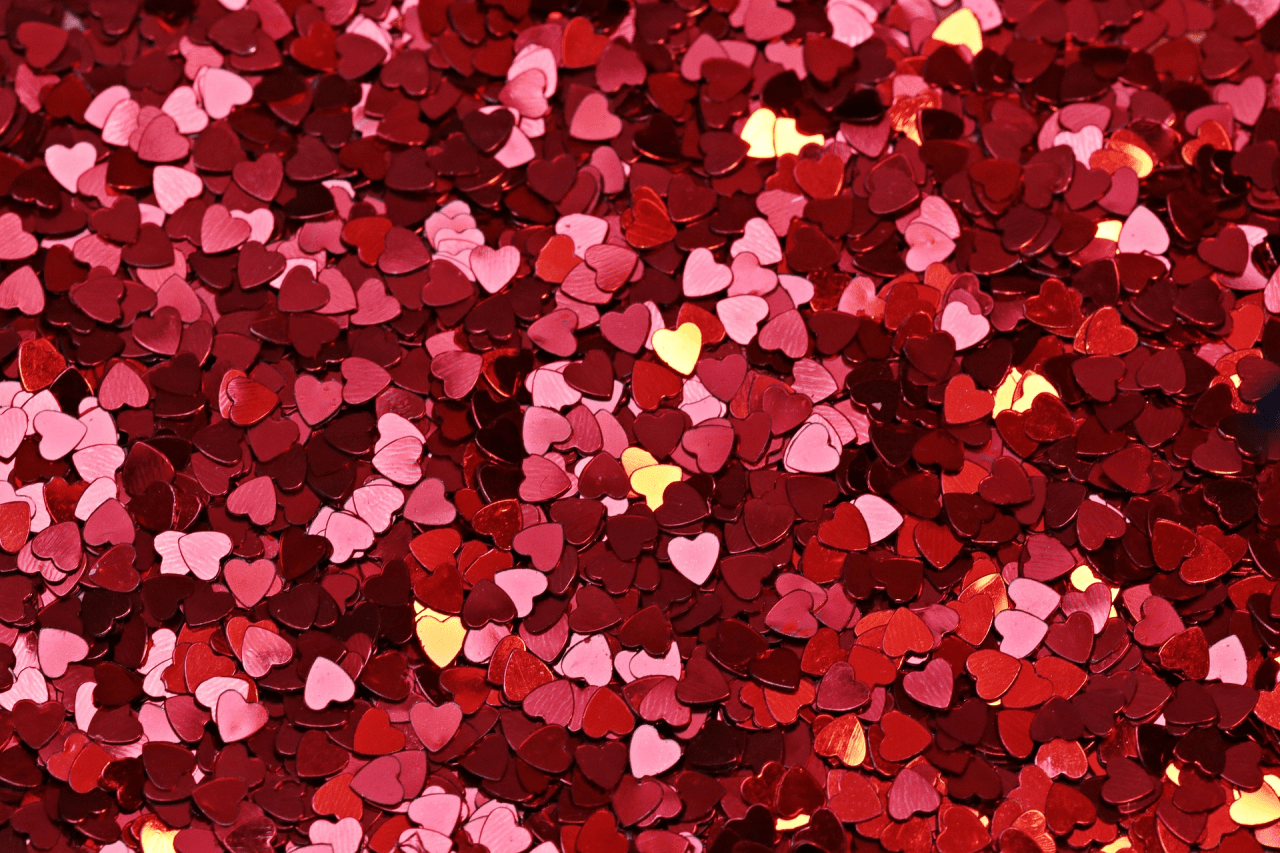 A background of red and pink heart shaped confetti. - Lovecore