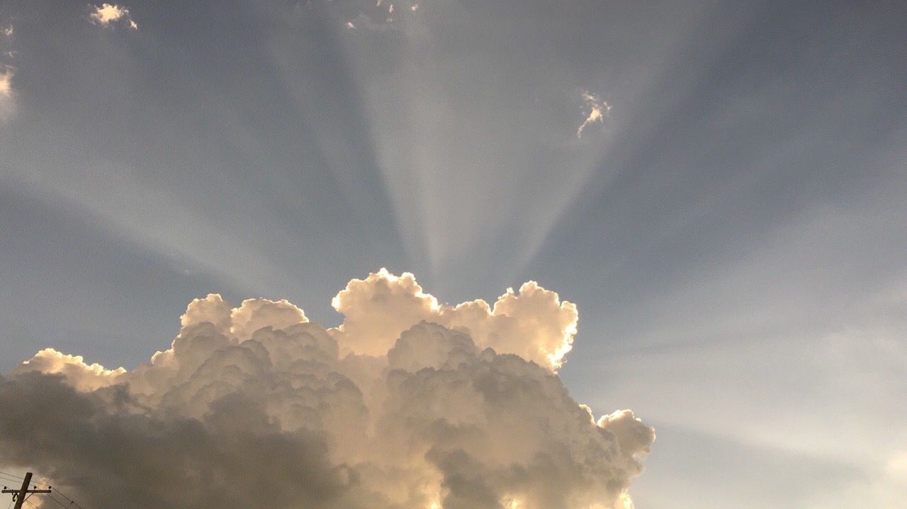 A cloud formation with a sun beam going through it - Angelcore