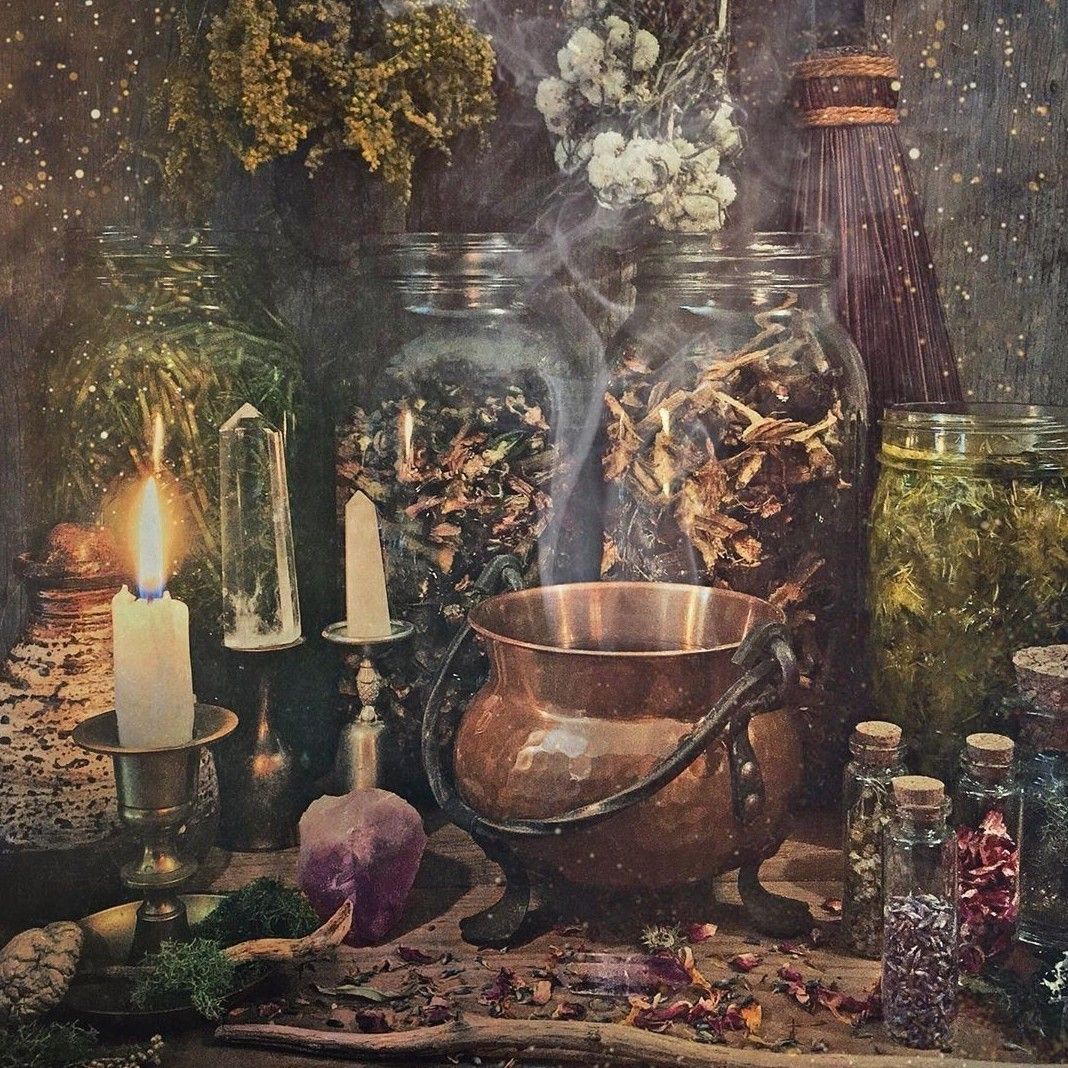 A still life arrangement of herbs, candles, and a cauldron. - Witchcore