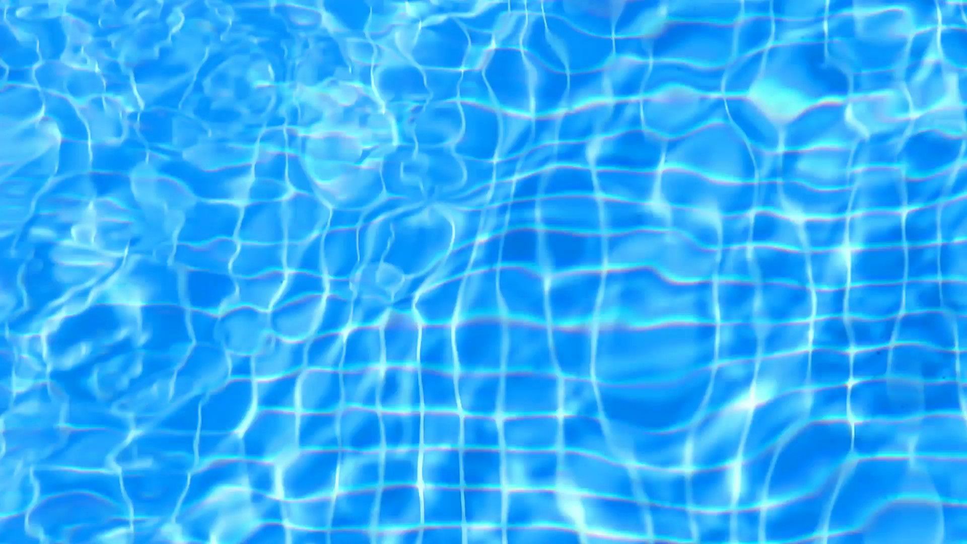 A pool with light blue water and white tiles. - Swimming pool