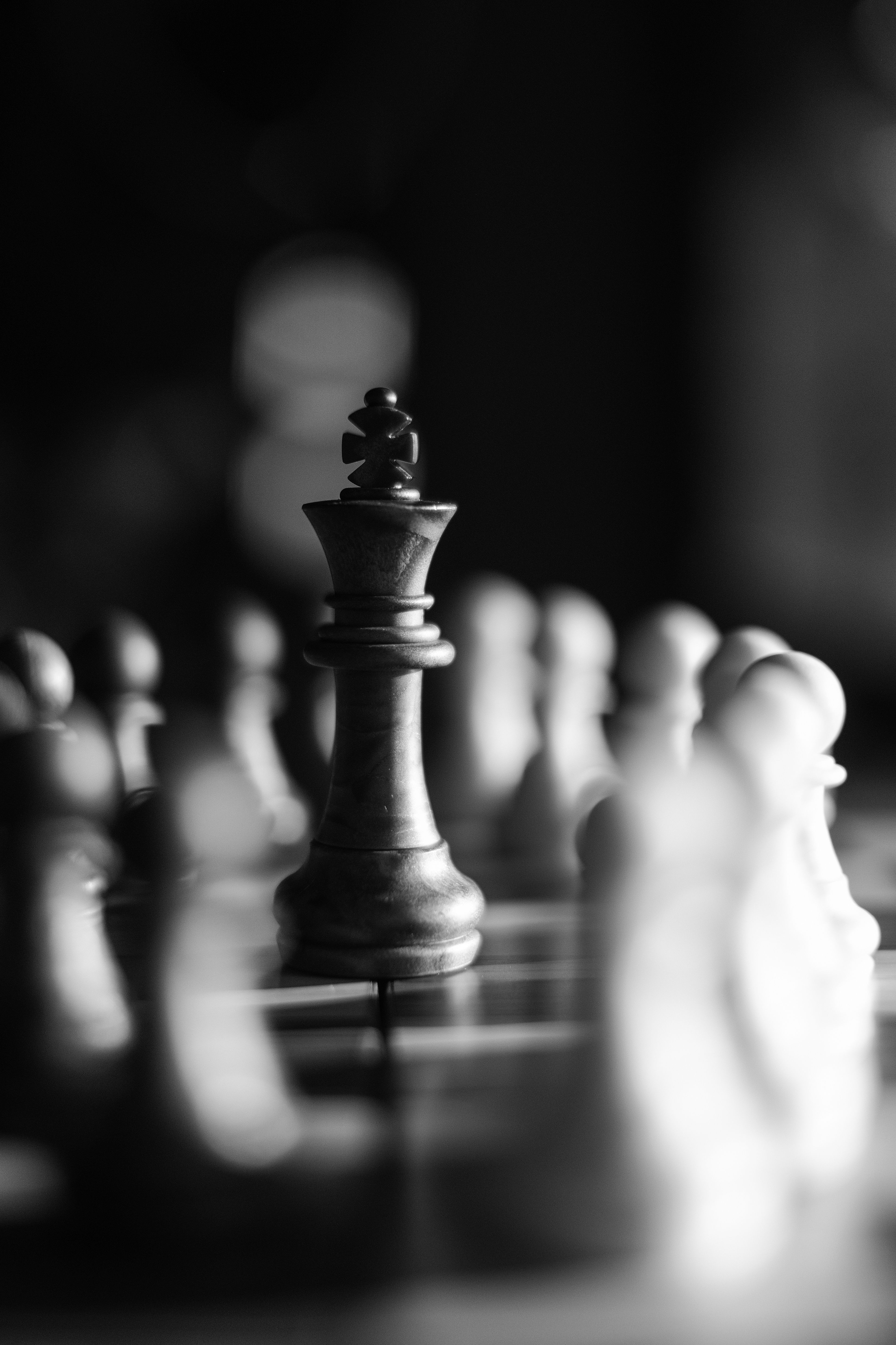 A black and white photo of chess pieces - Chess