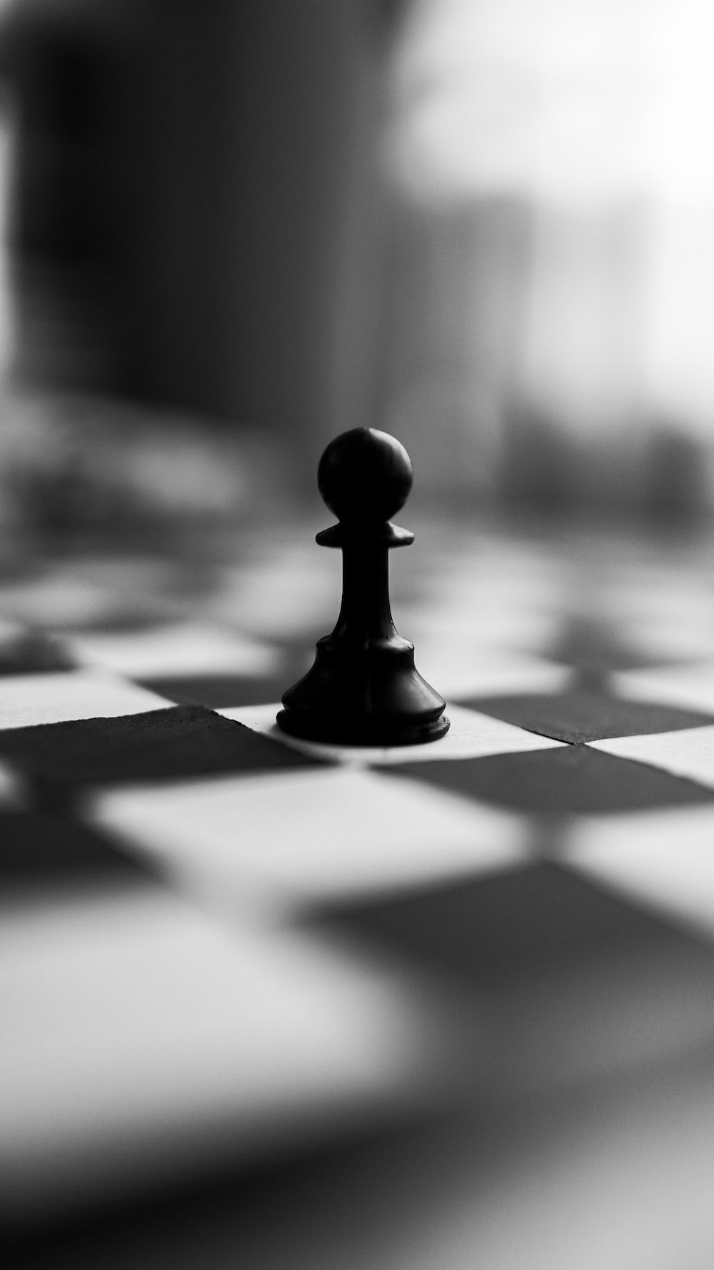 A black and white photo of chess pieces on the board - Chess