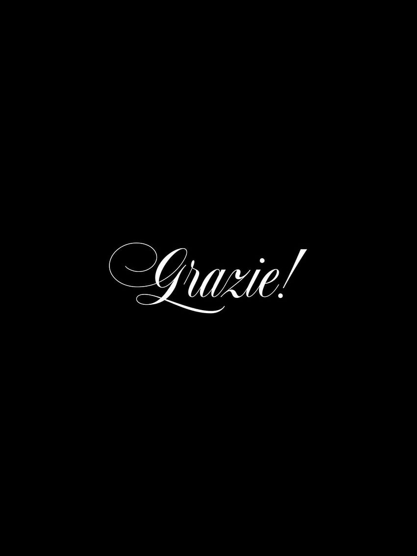 A black background with the word Grazie! in white cursive - Calligraphy