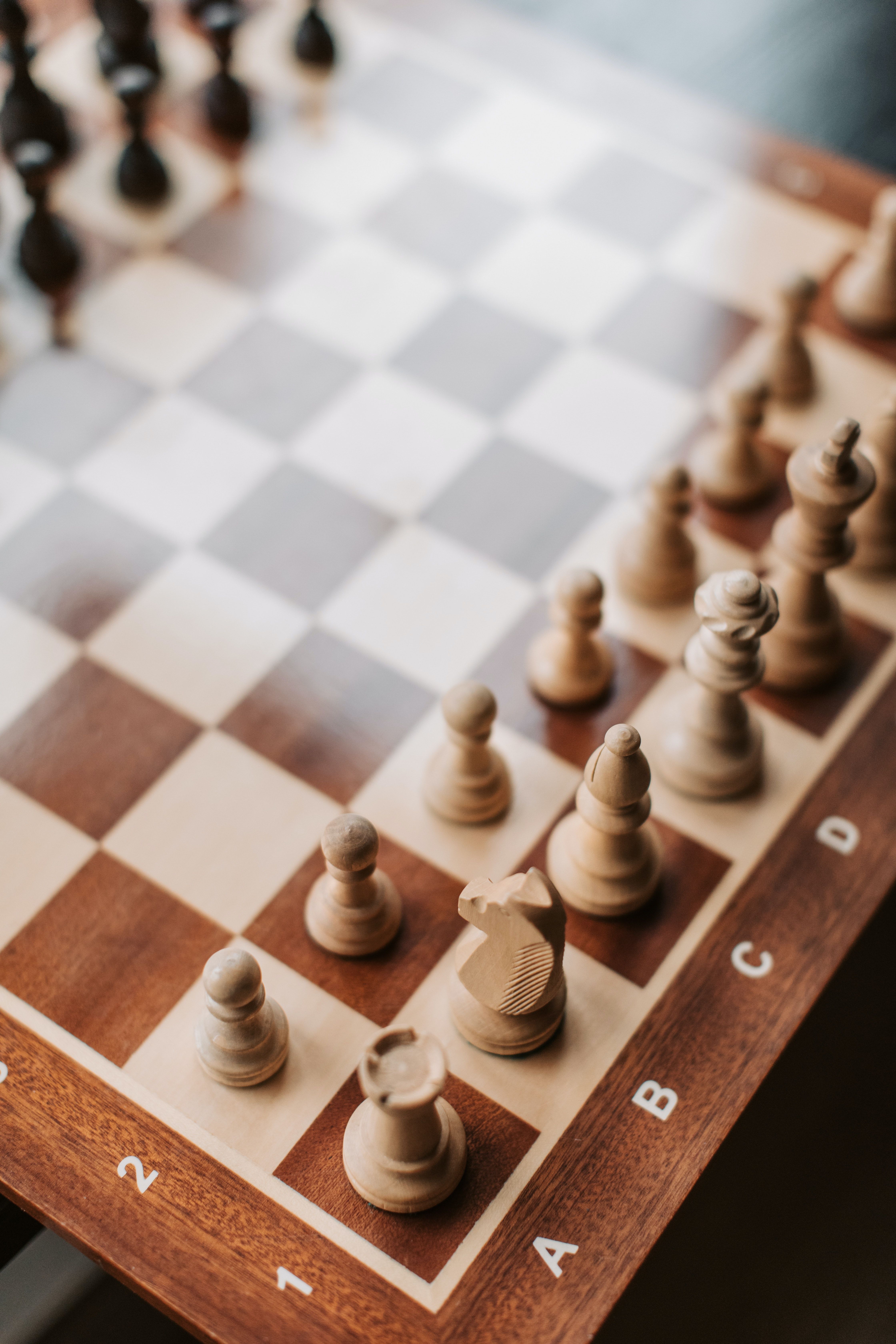 A chess board with a white and black chess set on it. - Chess