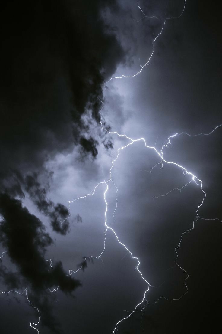 A lightning bolt strikes the sky in this dark photo - Storm, lightning