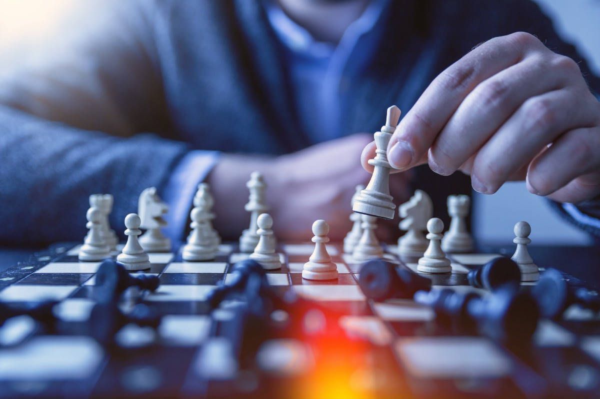 A man playing chess with a blurred background - Chess