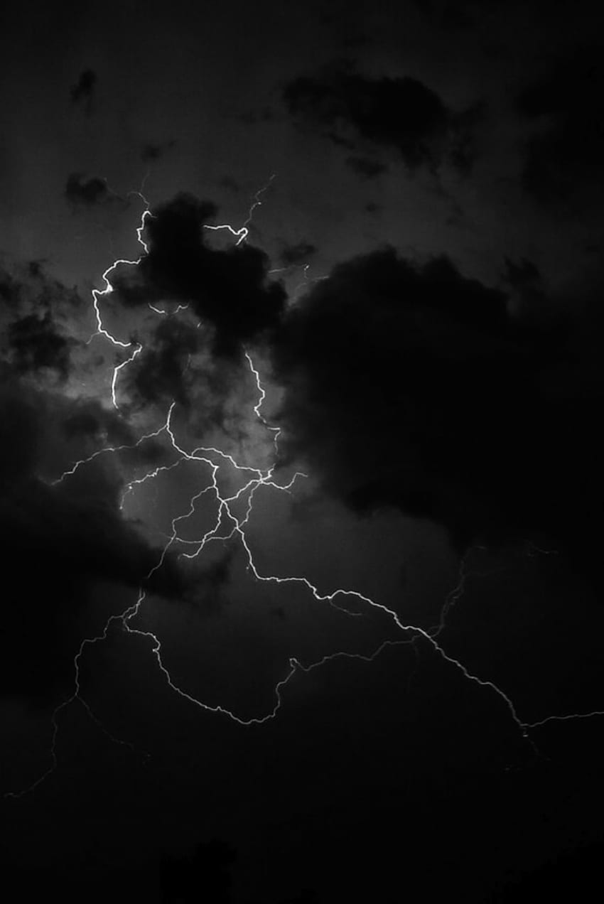 A black and white photo of a lightning bolt in the sky - Storm