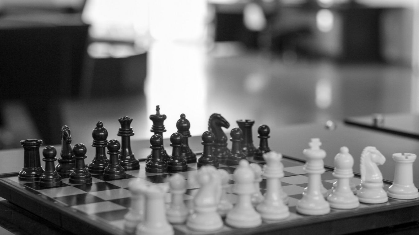 A chess board with a black and white set up - Chess