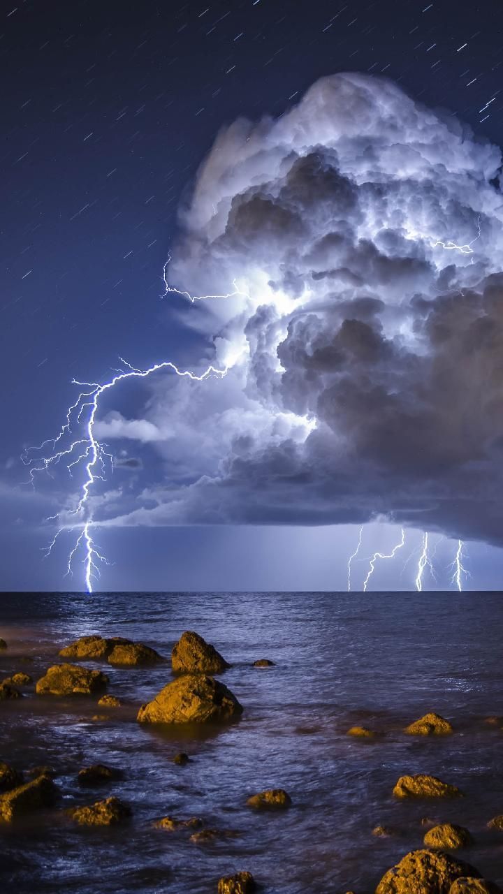 A lightning storm over the ocean at night - Storm