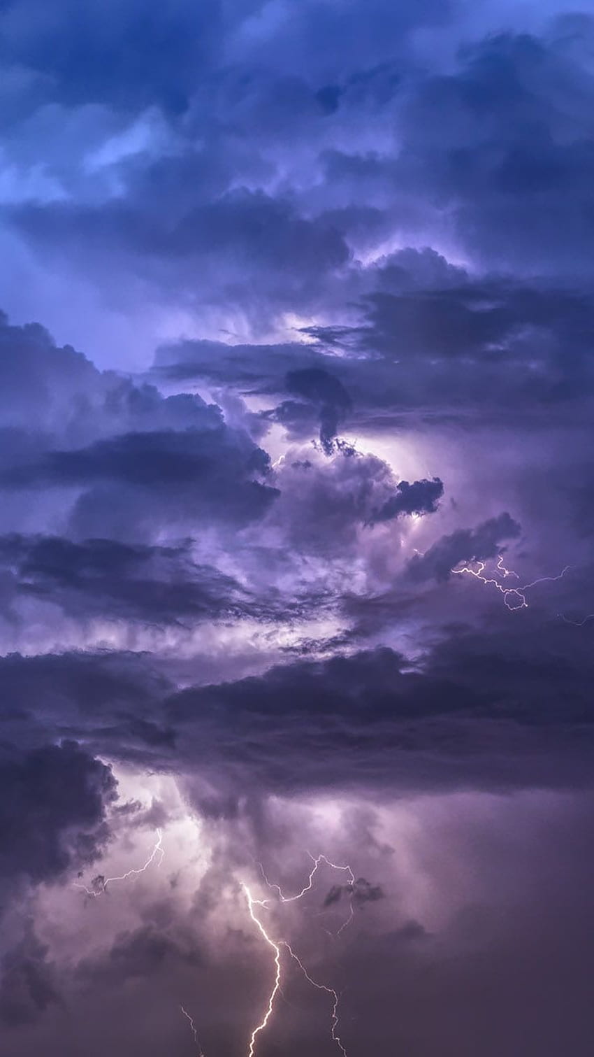 Lightning strikes over a dark sky with clouds - Storm
