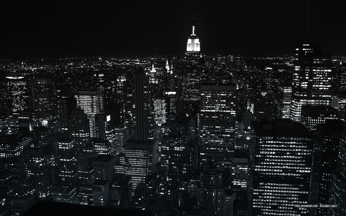 Black and white photograph of the city of New York at night. - 1440x900