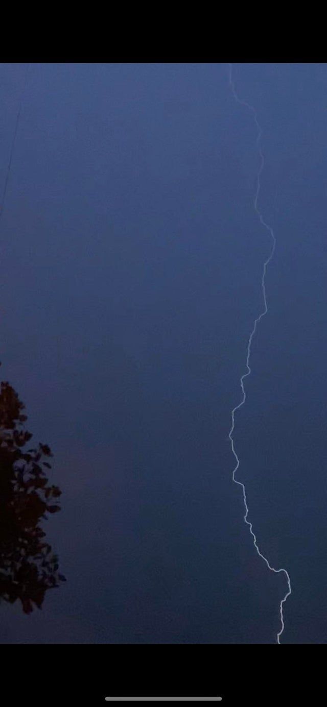 A photo of a bolt of lightning in the sky. - Storm