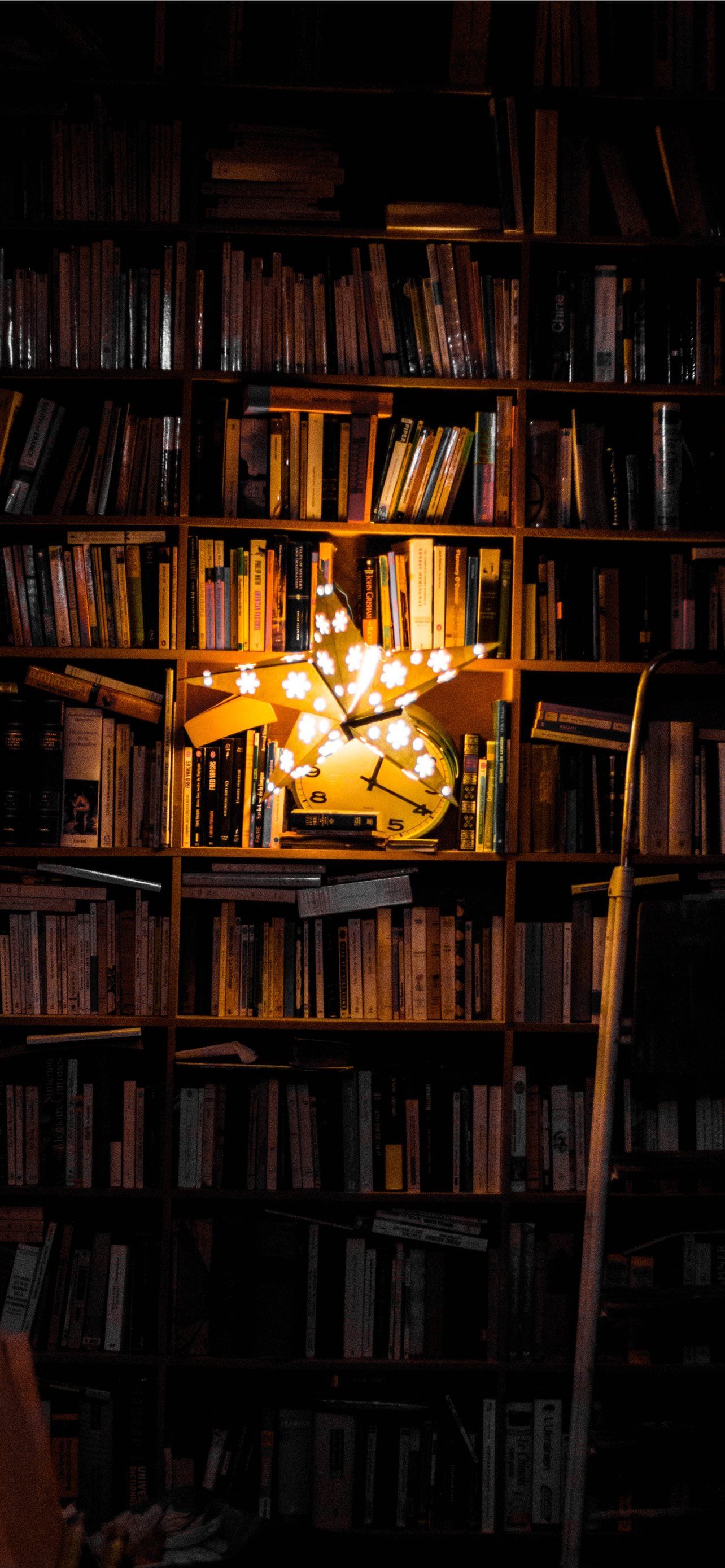 A bookshelf with a vase of flowers in the middle - Bookshelf