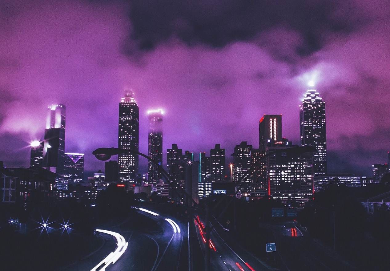 A city skyline with purple and pink lighting - Storm
