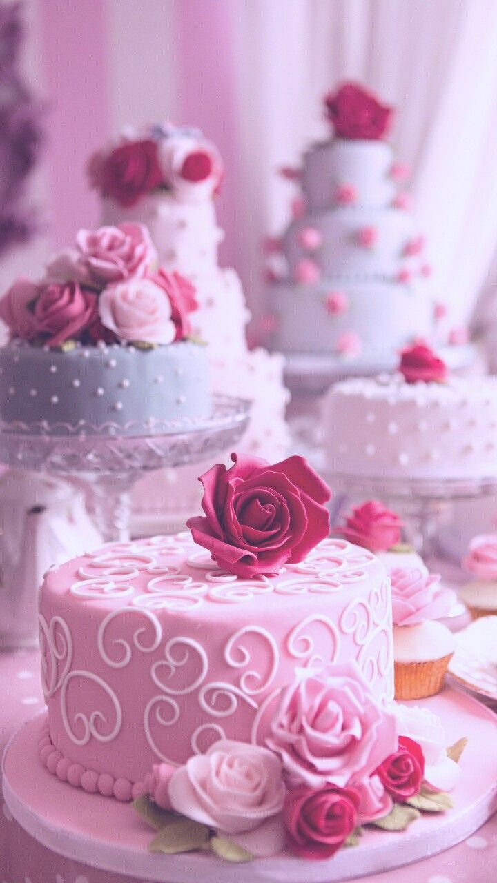 A table with several cakes and cupcaks on it - Cake