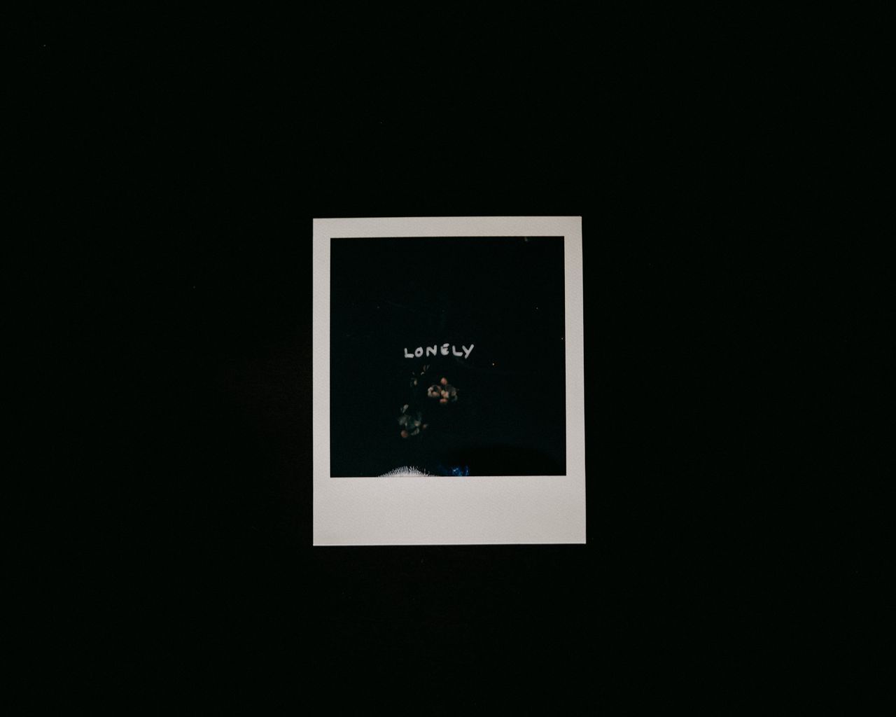 A polaroid picture of a person with the word lonely written on it. - 1280x1024