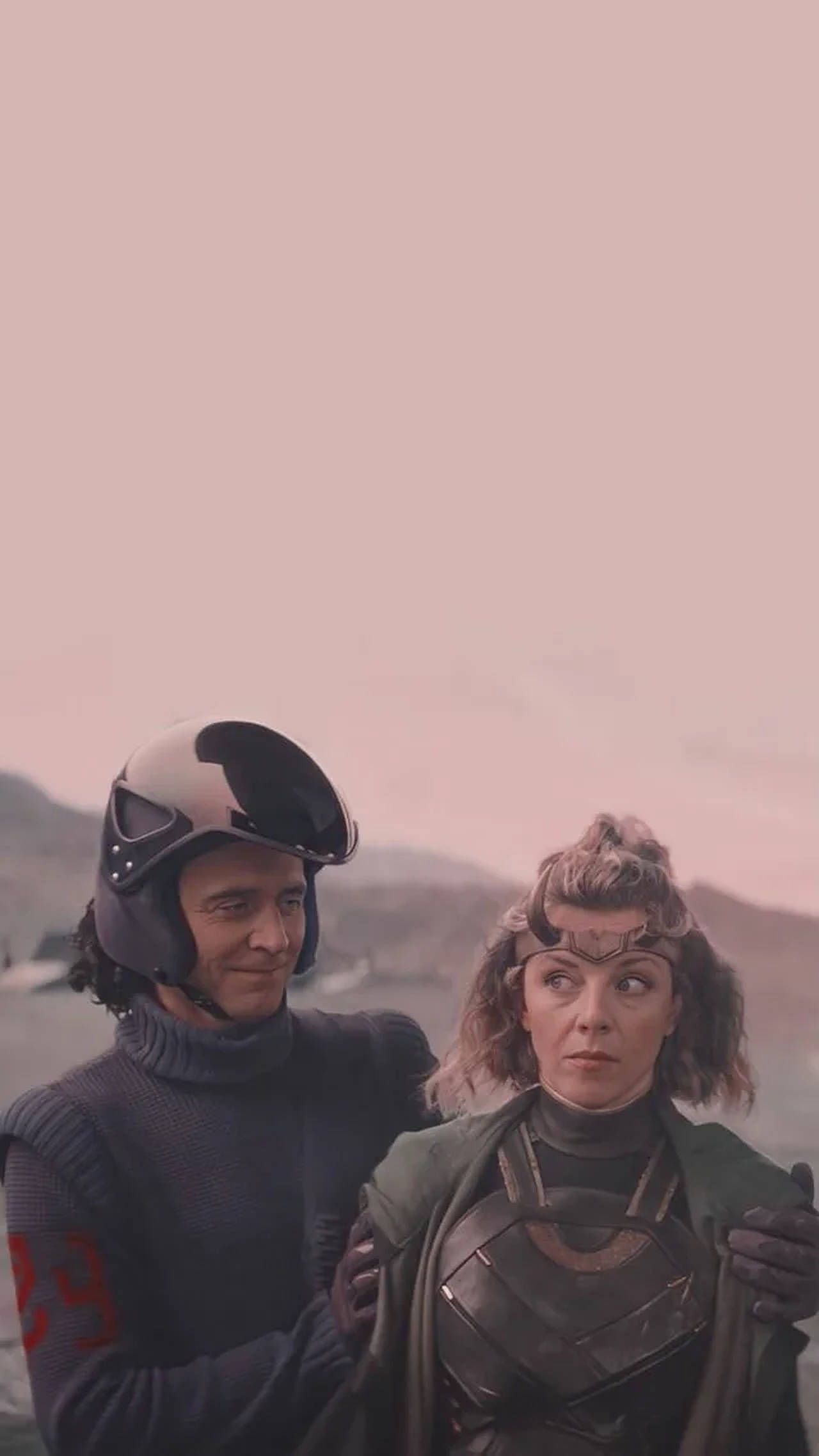 A man and woman standing together in the desert - Loki
