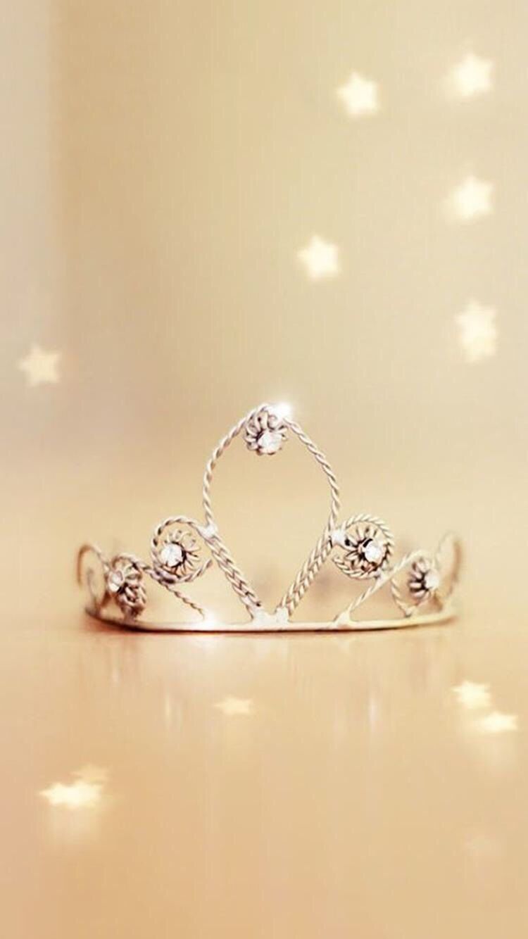 A silver tiara with a heart in the middle and stars in the background - Crown