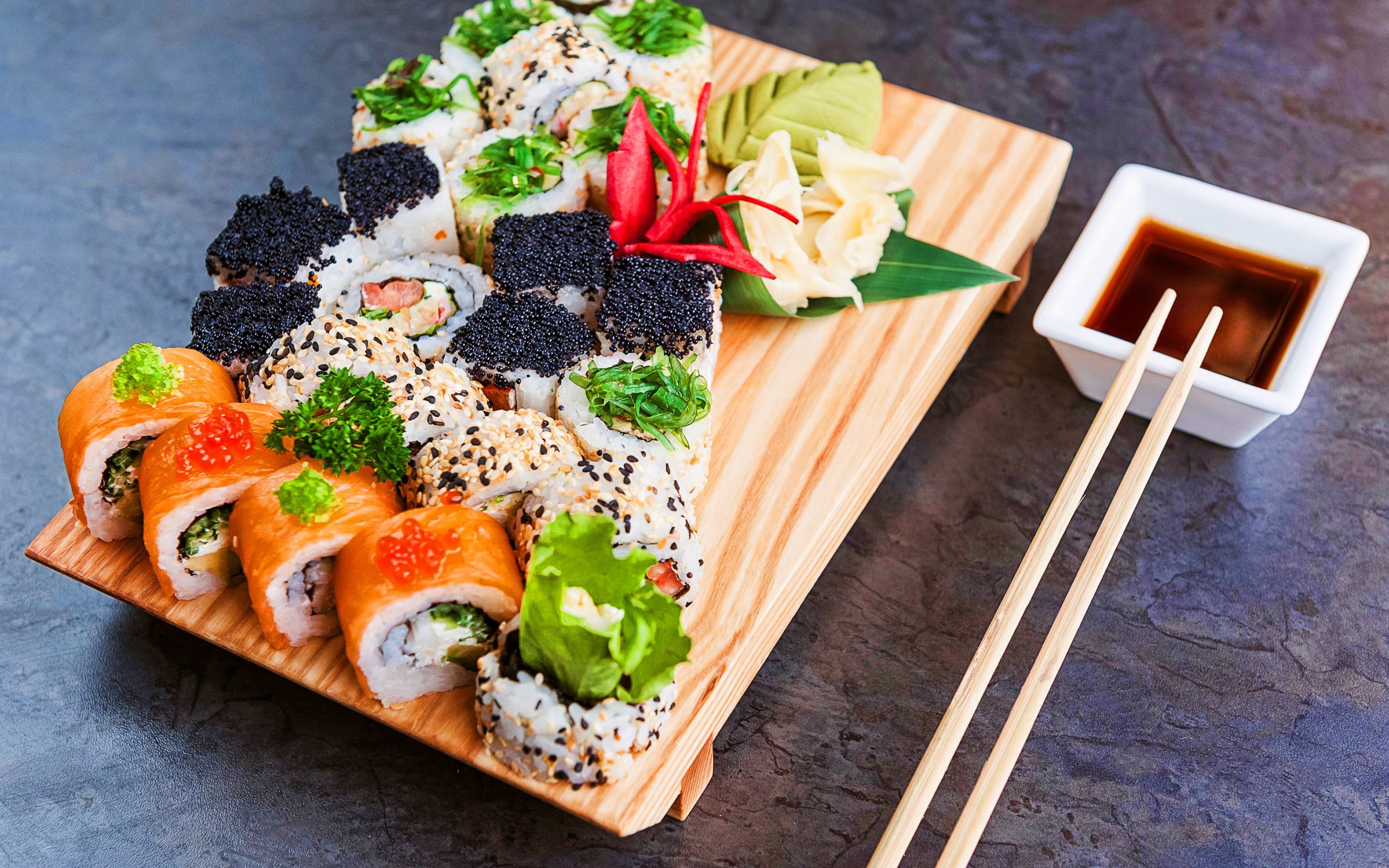 A sushi platter with chopsticks on the side - Sushi