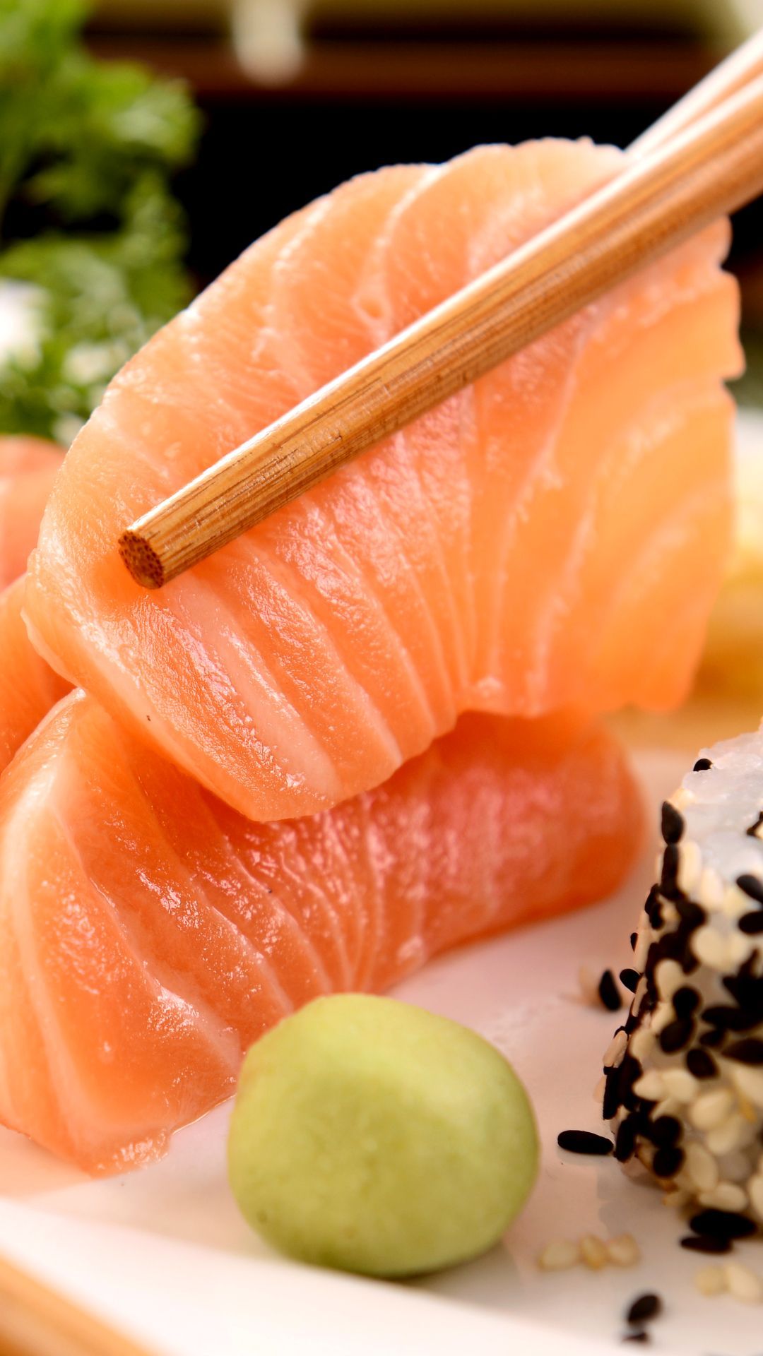 A plate of sushi with chopsticks and garnish - Sushi