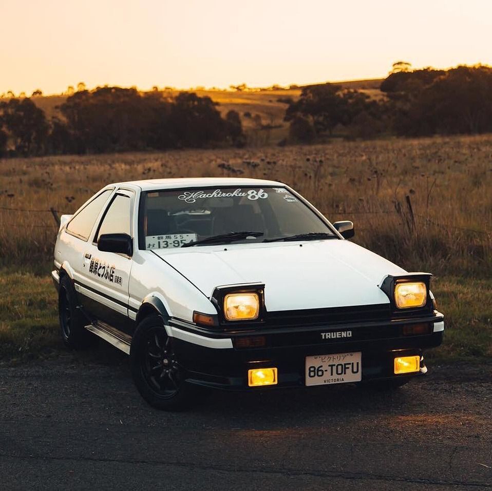 A white car parked on the side of road - Toyota AE86