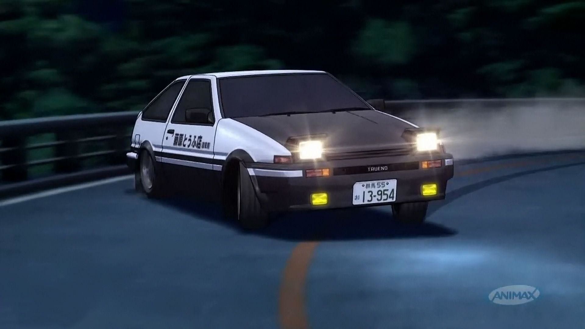 A white car with yellow lights is driving down a road at night. - Toyota AE86