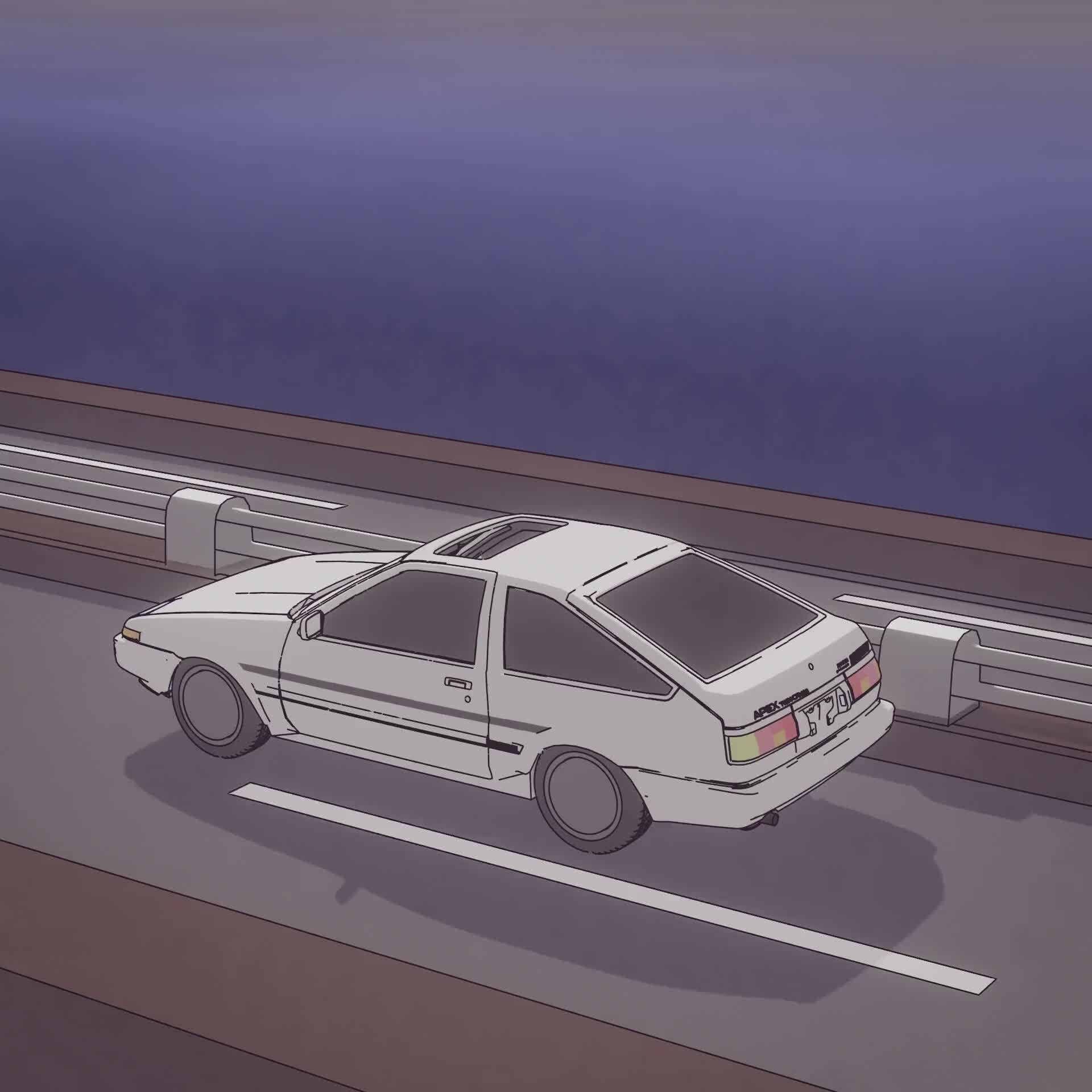 A white car driving on a road with a body of water in the background - Toyota AE86