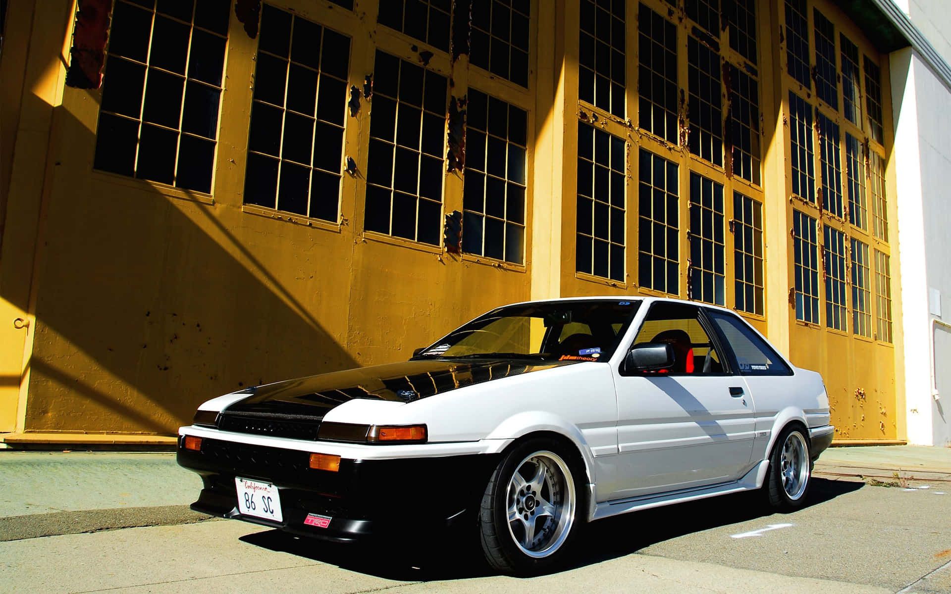 A car parked on the side of an empty street - Toyota AE86