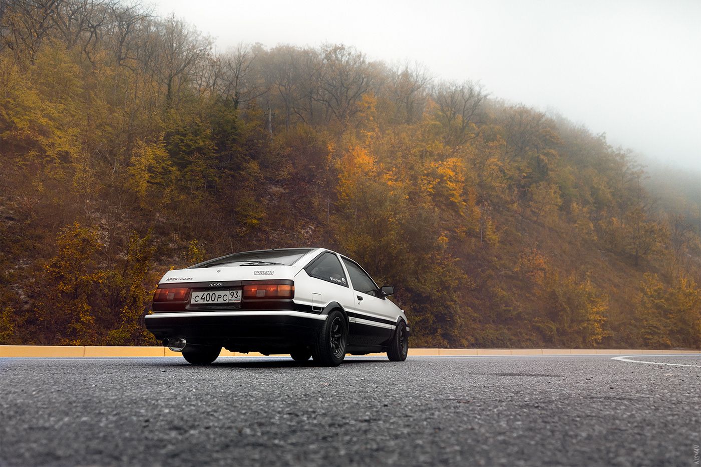 A car is driving down the road - Toyota AE86