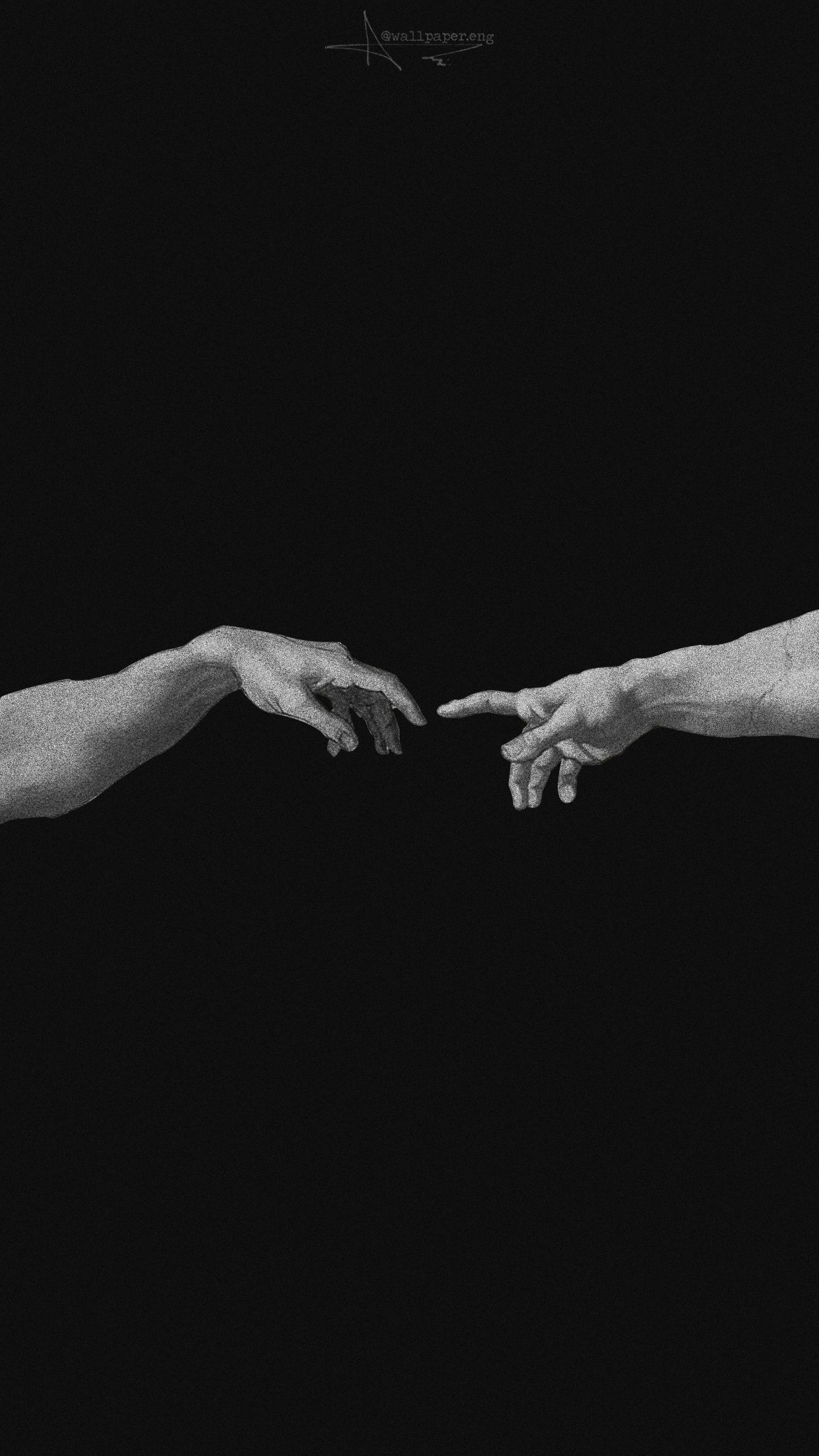 A black and white photograph of two hands reaching out - Black and white