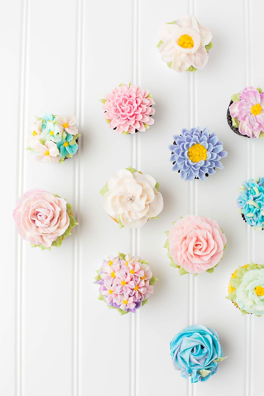 HD wallpaper: flower cupcakes on white surface, top view photography of assorted flower cupcakes