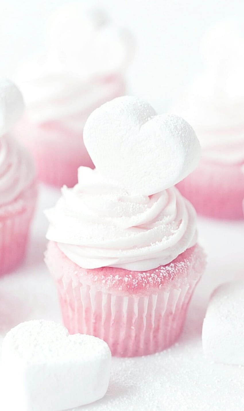 A cupcake with white frosting and marshmallows - Cupcakes