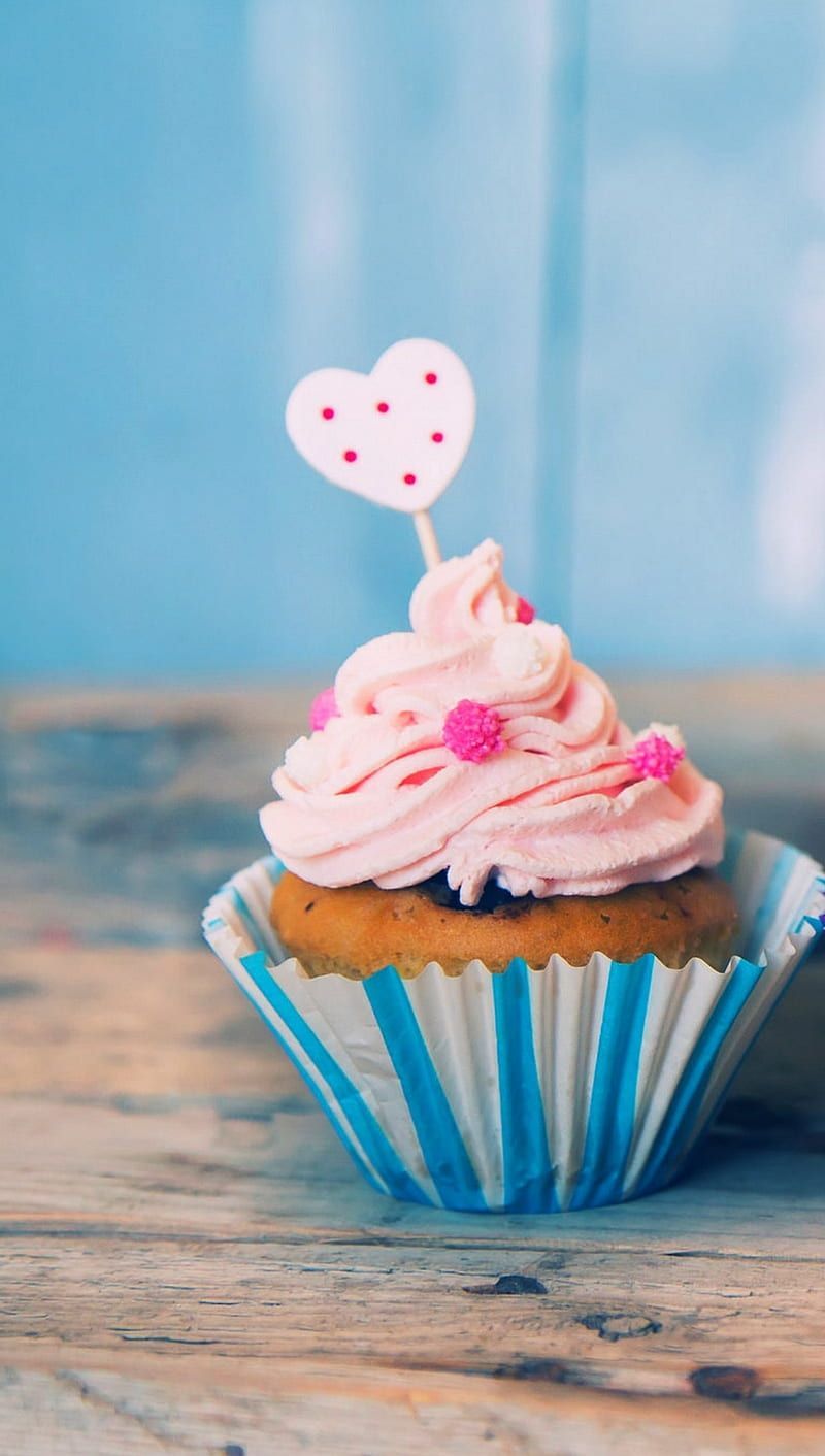 A cupcake with pink frosting and heart on top - Cupcakes