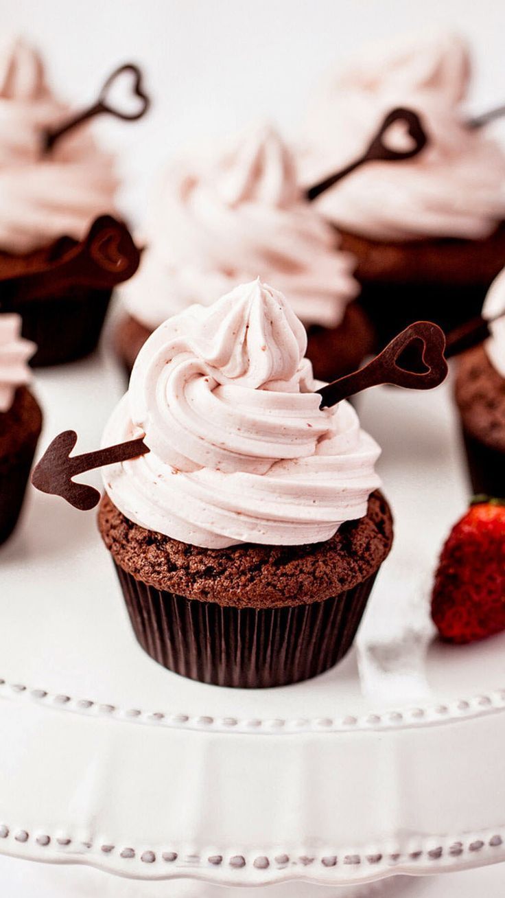 A plate of cupcakes with strawberries on top - Cupcakes