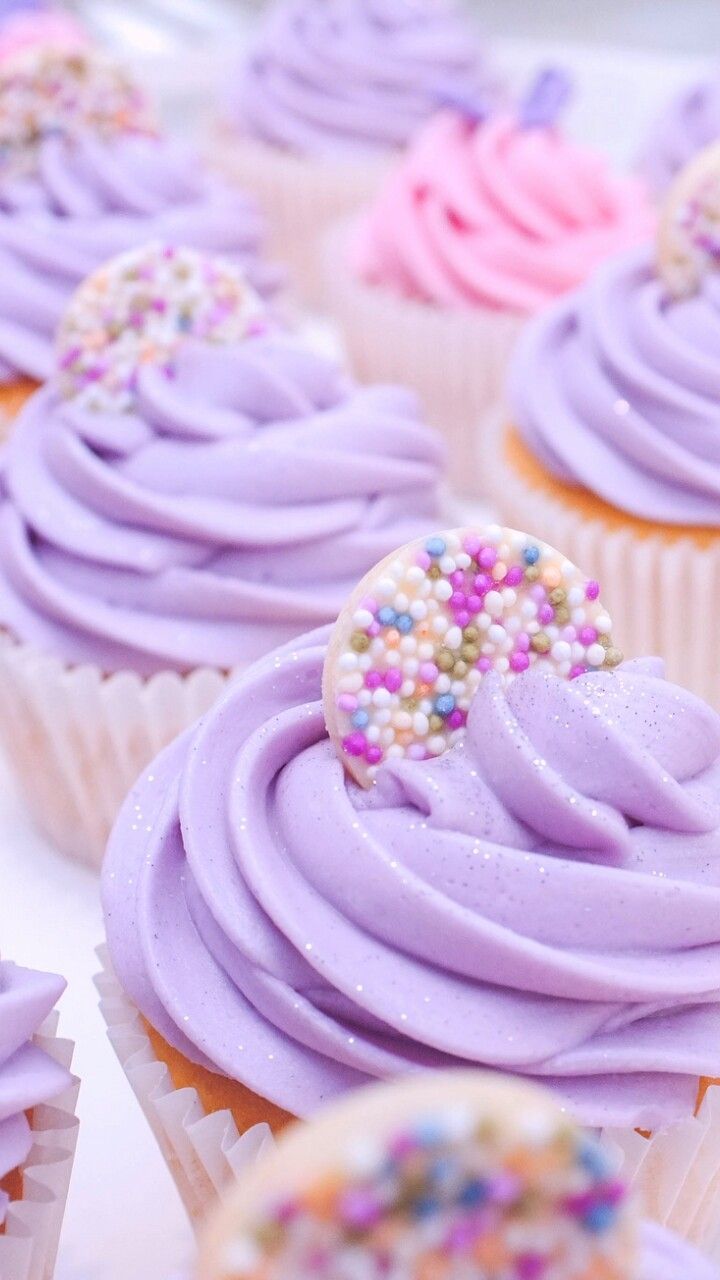 A close up of cupcakes with purple frosting - Cupcakes