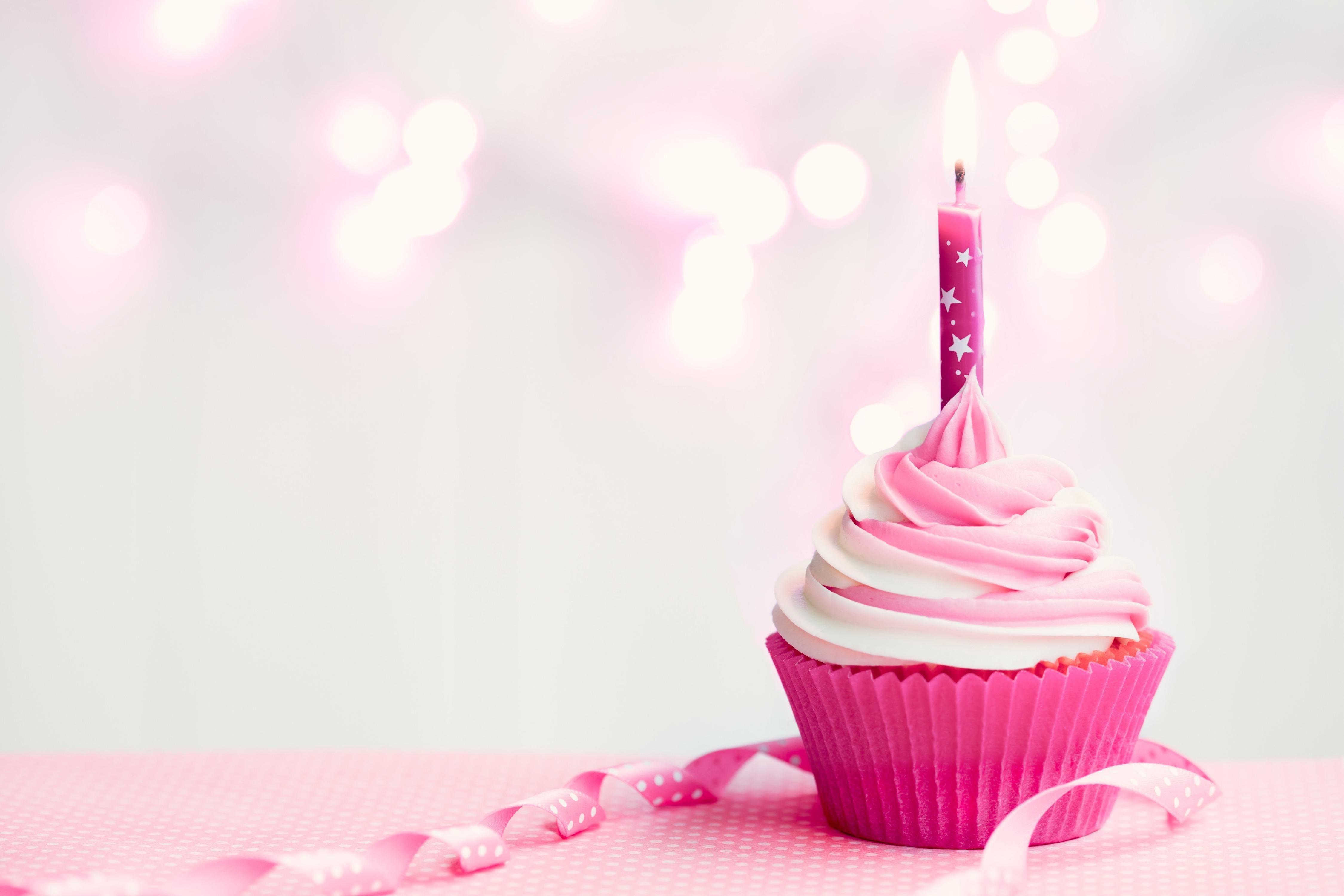 A cupcake with candle and pink ribbon - Cupcakes