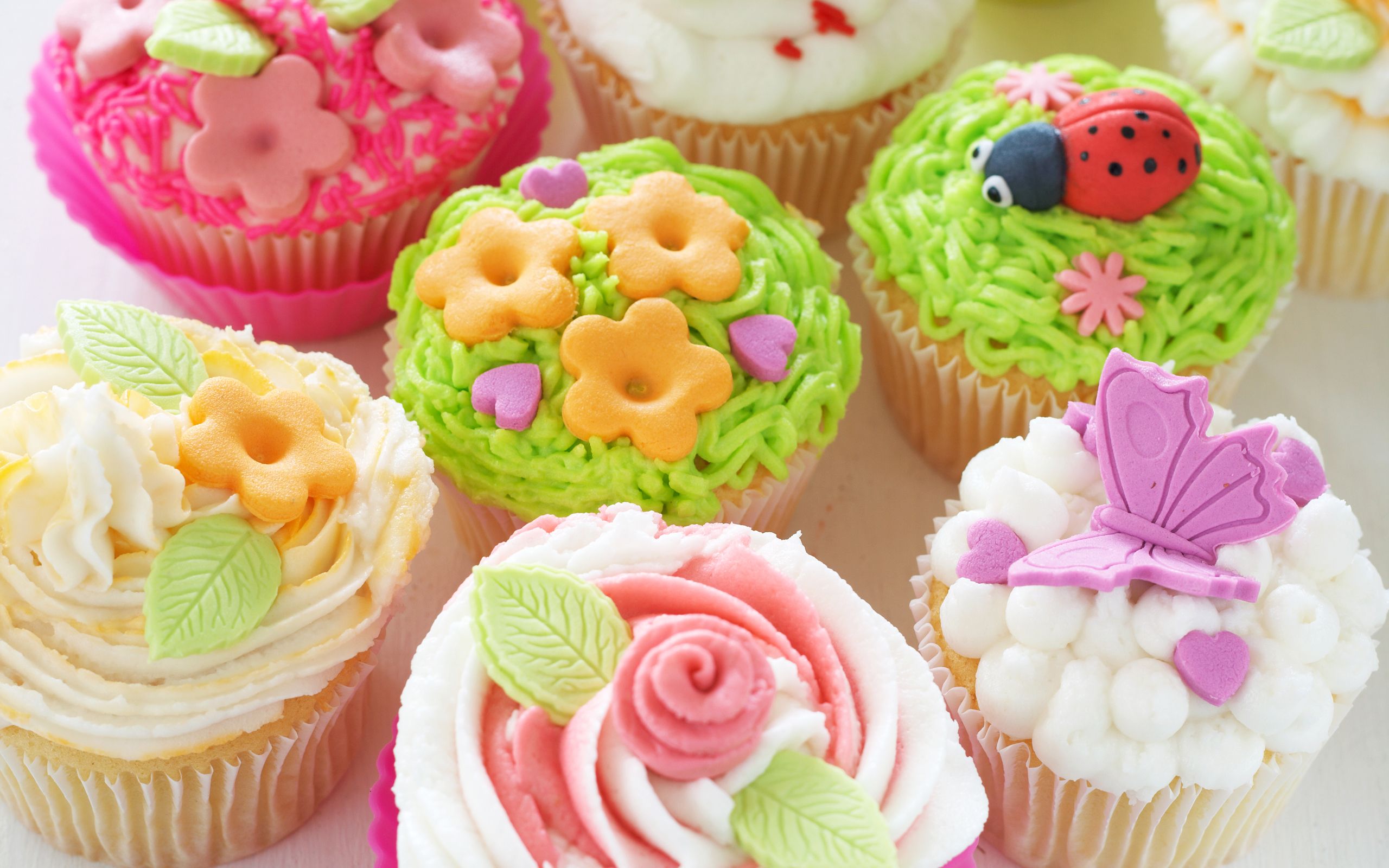 A close up of a table with a bunch of cupcakes on it - Cupcakes