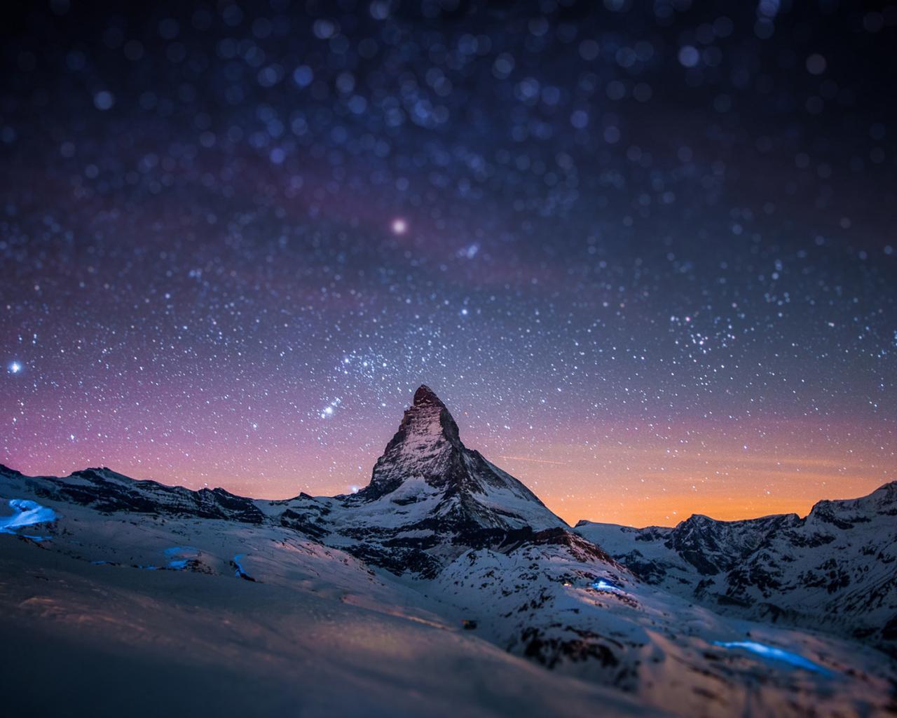 The Matterhorn mountain in Switzerland under a starry sky - 1280x1024