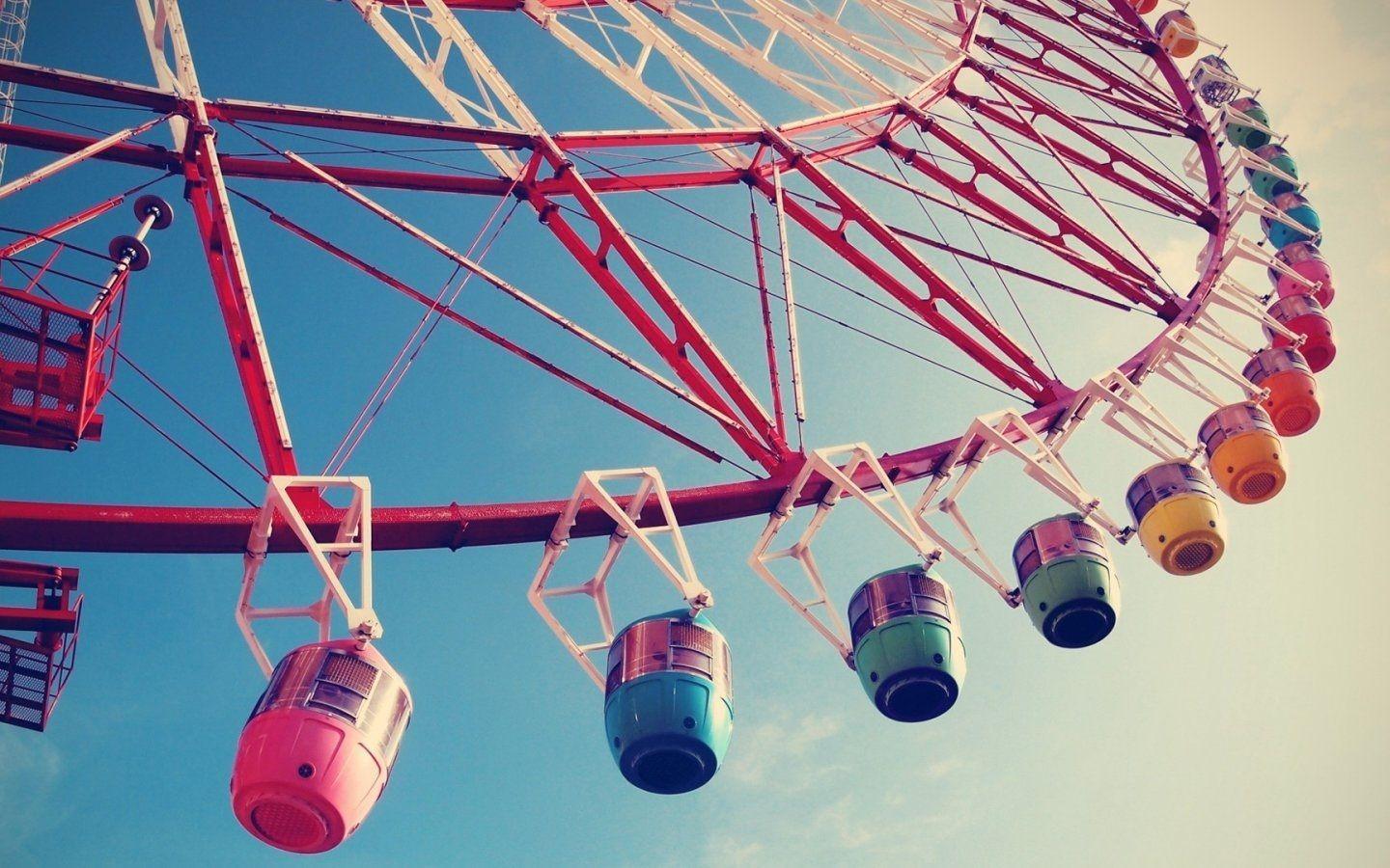 A colorful ferris wheel against a blue sky. - 1440x900