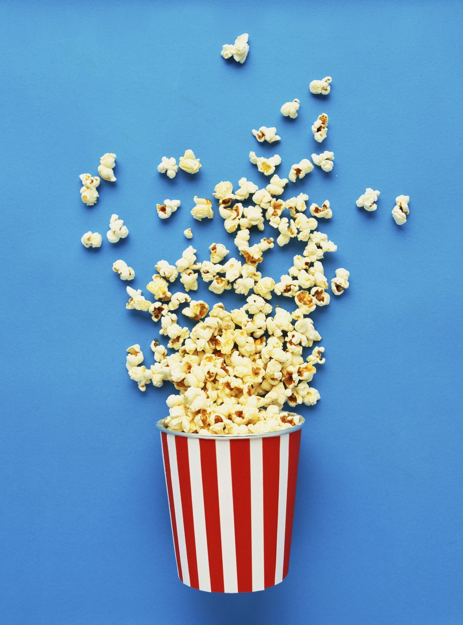 A cup of popcorn with kernels falling out - Popcorn