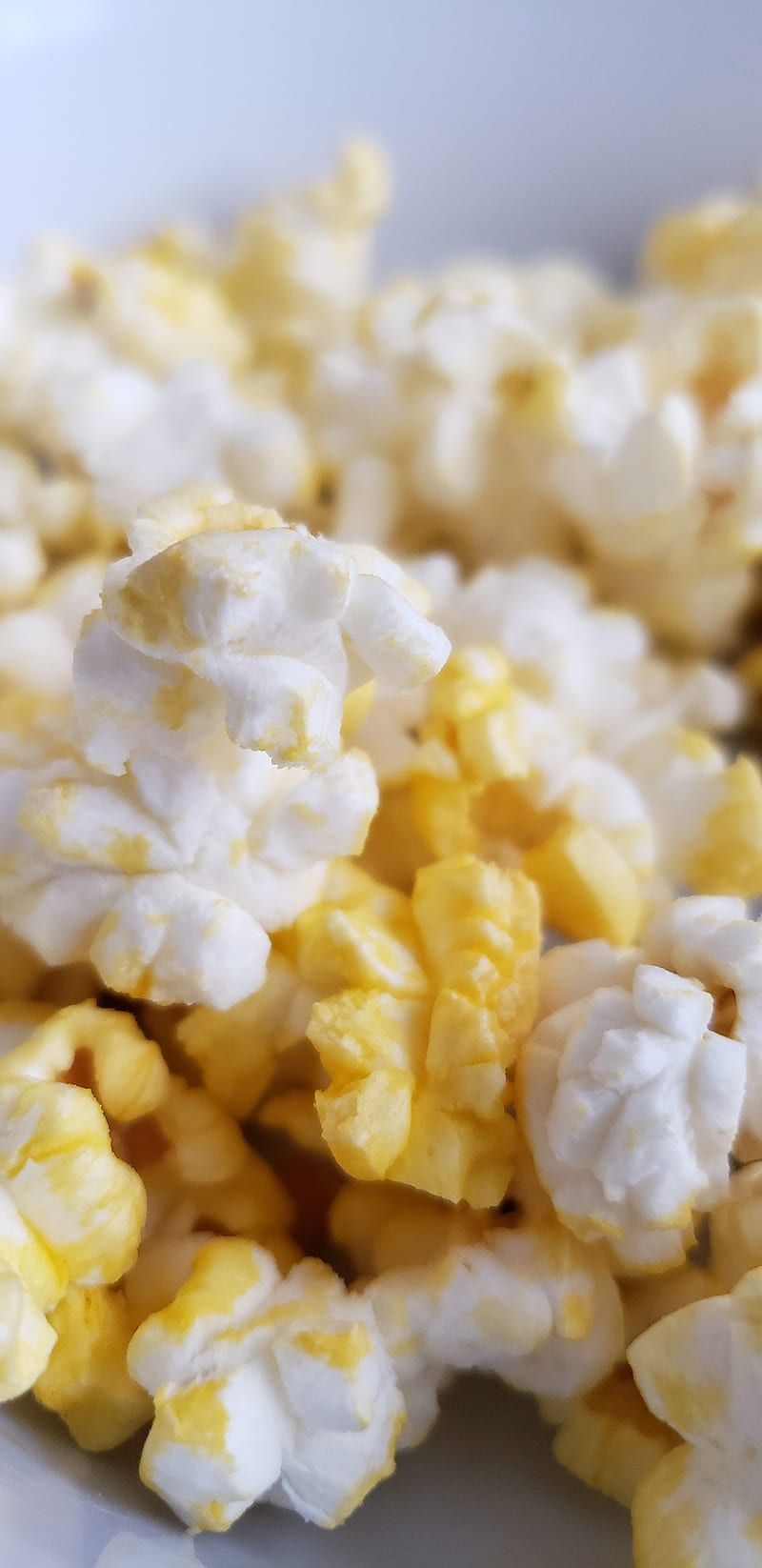 Popcorn in a white bowl on a white table - Popcorn