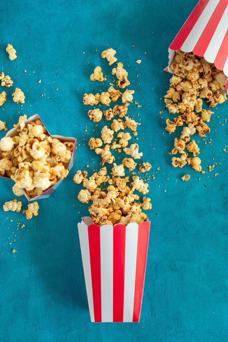 A bowl of popcorn is being poured into another container - Popcorn